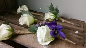 White rose with purple buttonholes