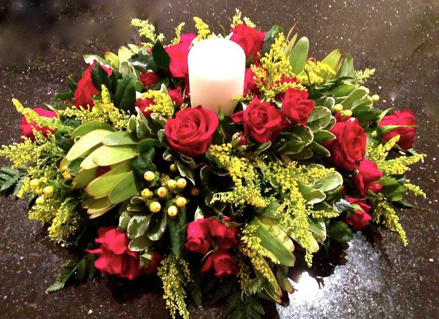 Candle table arrangement with spray roses and protea