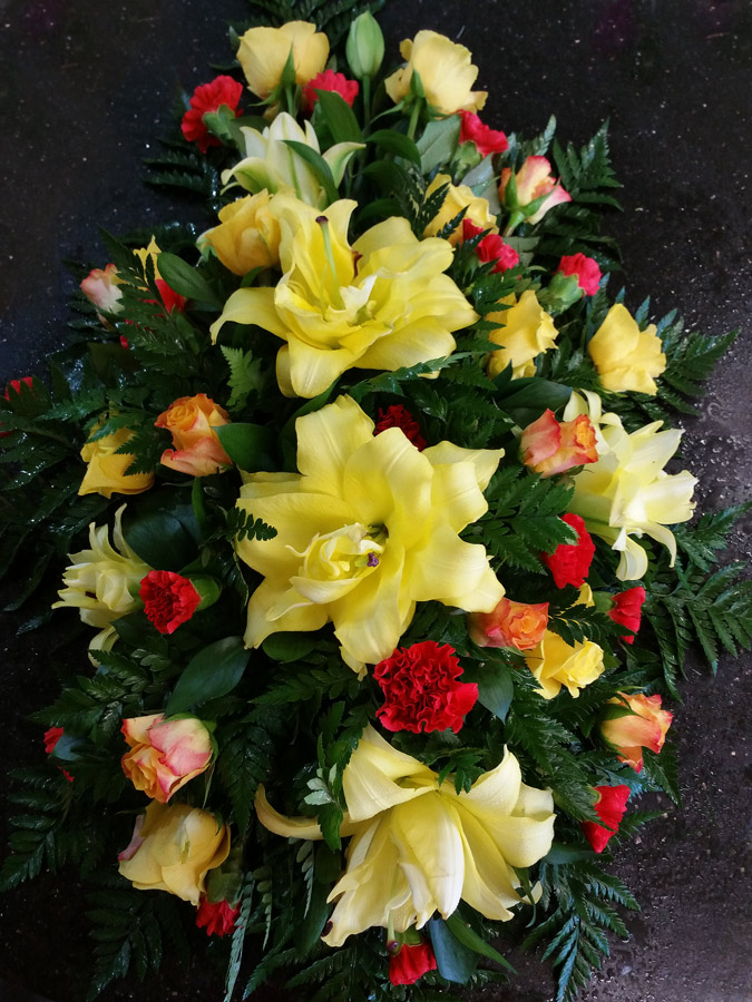 Yellow lily and orange rose, red carnation single ended spray