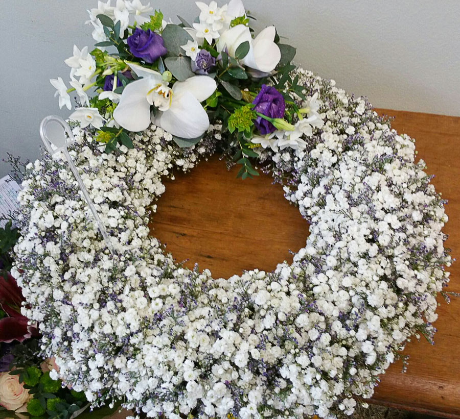 Based Open Wreath tribute - gypsophilia, orchids and lisianthus - white and purple