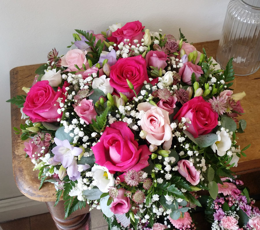 Posy pad - 16 inch loose flower tribute - pink roses, white and purple freesias and lisianthus