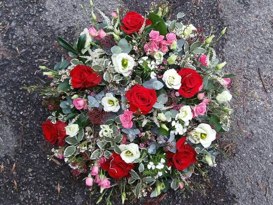 Posy pad - 16 inch loose flower tribute - spray roses and lisianthus - red, pink and white