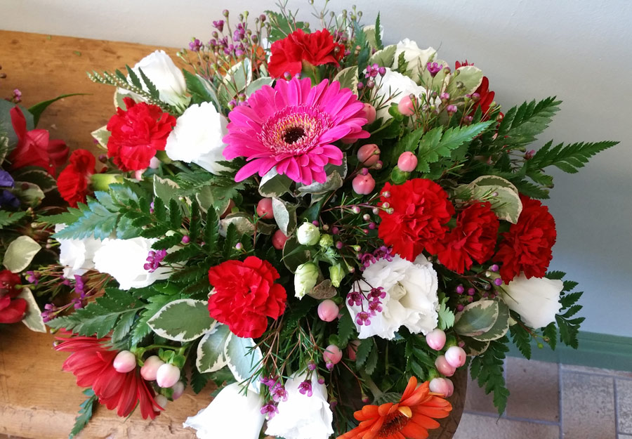 Posy pad - 16 inch loose flower tribute - red spray carnation, white rose and pink gerbera