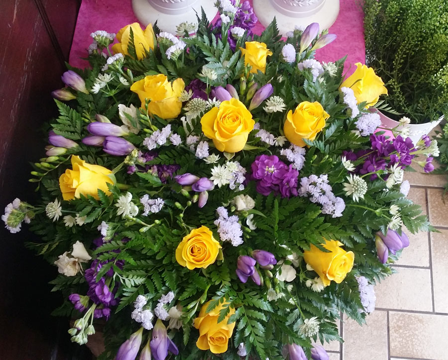 Posy pad - 16 inch loose flower tribute - yellow rose, purple freesia and stock
