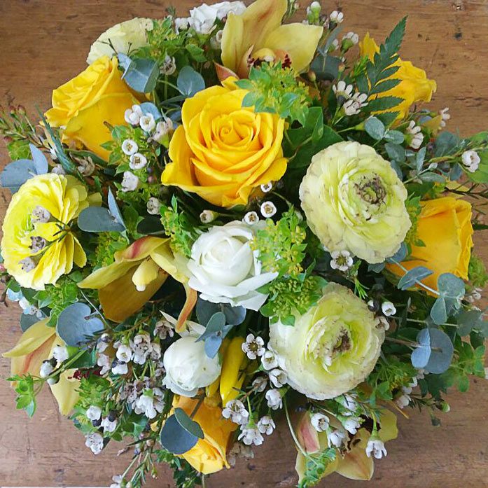 Small posy in a dish - yellow roses, green ranunculus and white orchids
