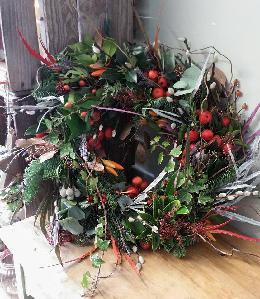 Christmas door wreath - pine, cones, ivy and red fruit and berries