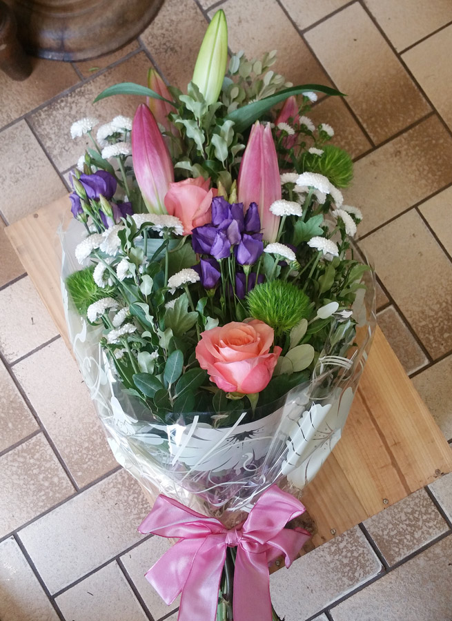 Forward-facing handtied- roses, lily, lisianthus and spray chrysanthemum