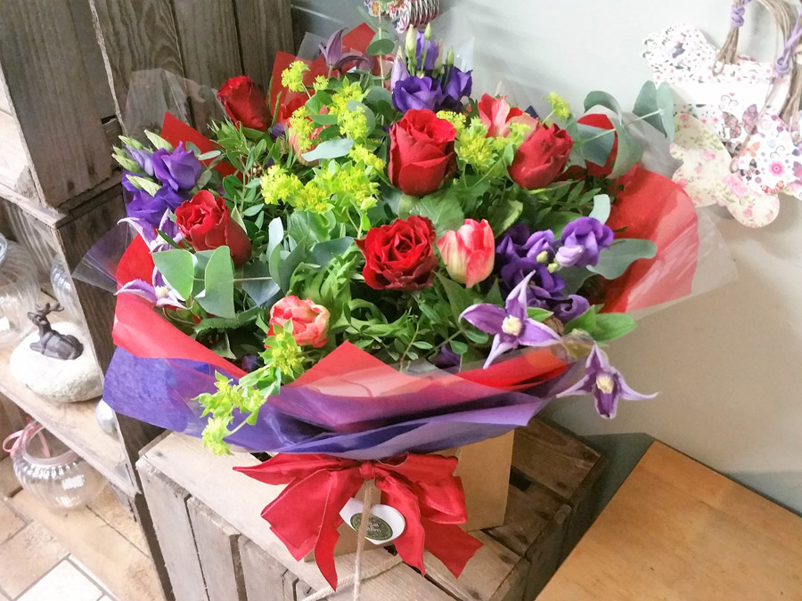Handtied gift bouquet - red roses and purple mix