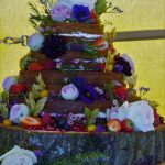 Fresh flowers decorating naked wedding cake