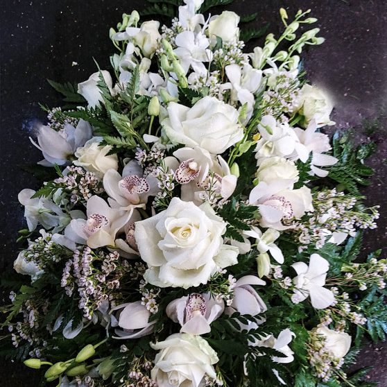 White orchid, rose and waxflower single ended spray
